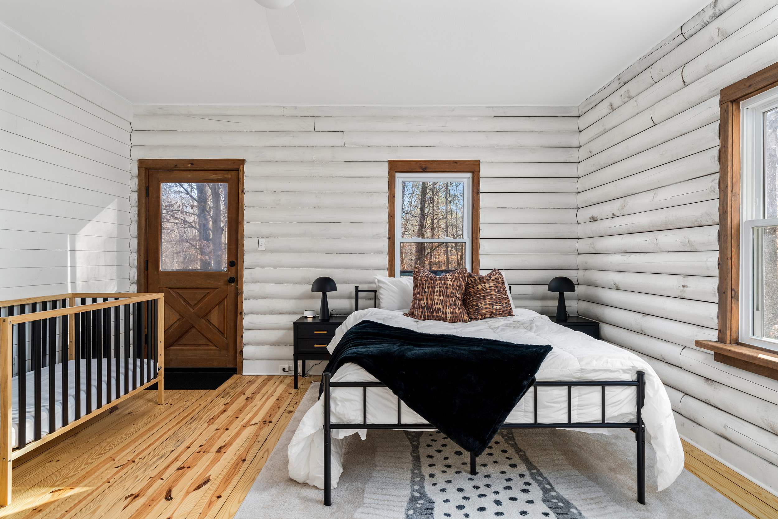 Bedroom 2: Serene space with serene woods view, featuring rustic decor and stylish comfort.