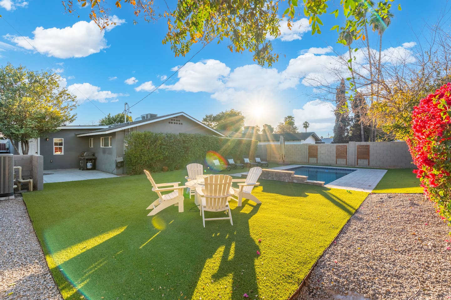 Sunlight striking the pool area, casting a warm glow on the water and creating a vibrant, inviting atmosphere.