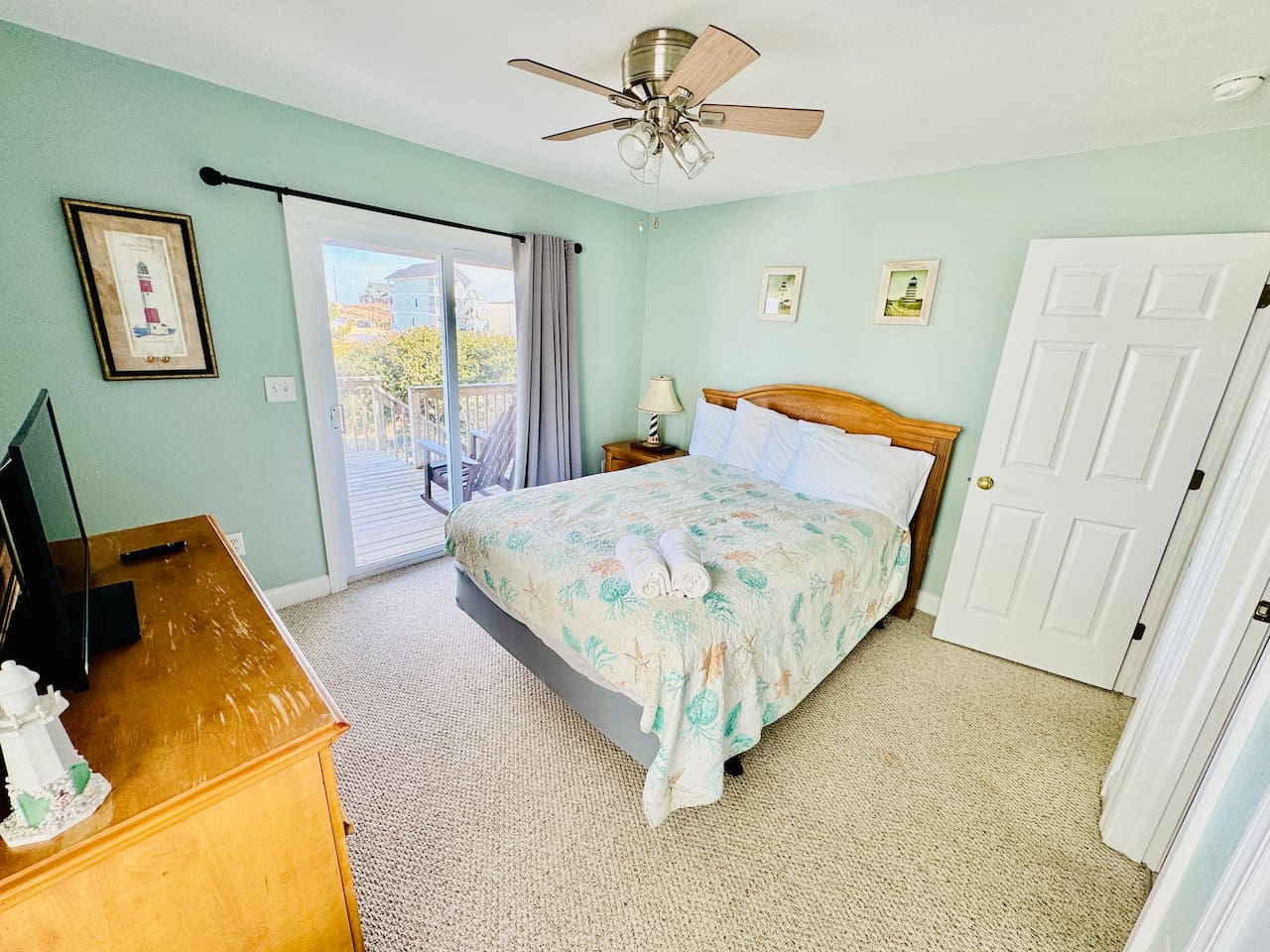 Cozy Queen bedroom with Smart TV and sliding door to deck.