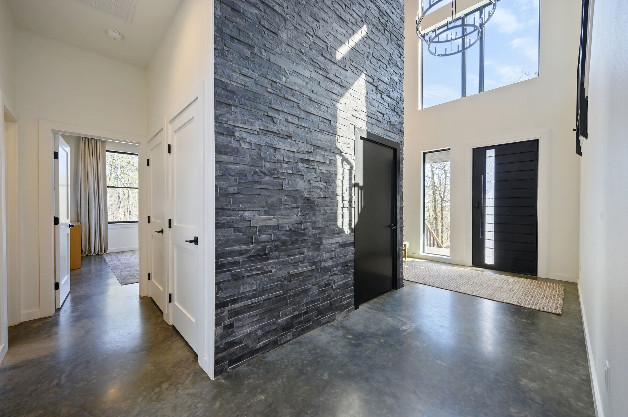 Main entrance to cabin, featuring a towering marble accent wall.