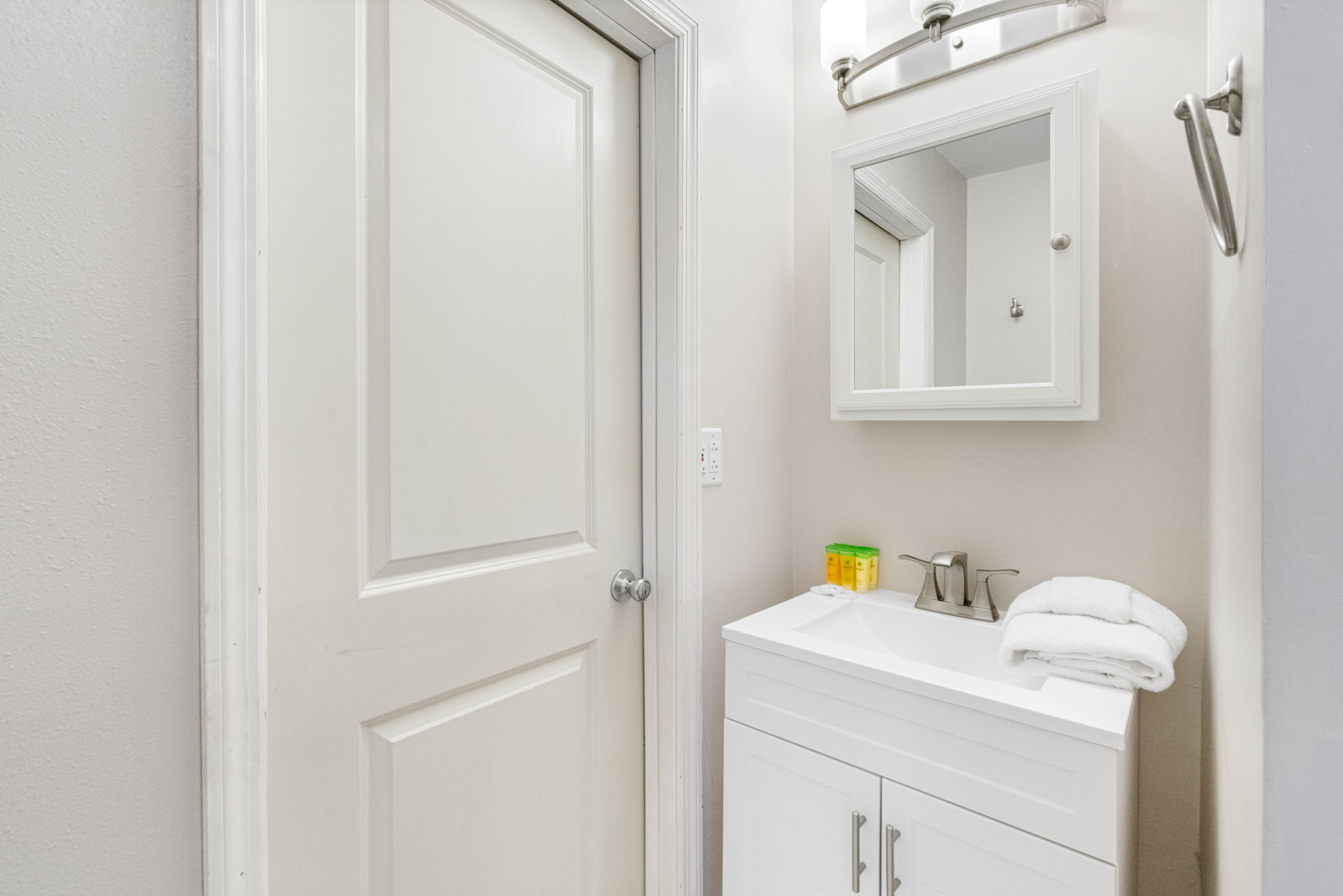 The standout feature is the generously sized walk-in shower, finished in rich natural stone tiles with a textured pebble-style floor.
