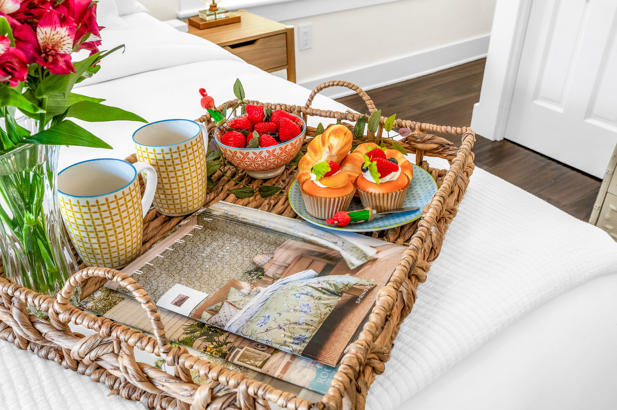 Serene king primary suite featuring a smart TV, private en-suite bathroom, and elegant French doors that open directly to the pool—perfect for seamless indoor-outdoor living and relaxing mornings or evenings.