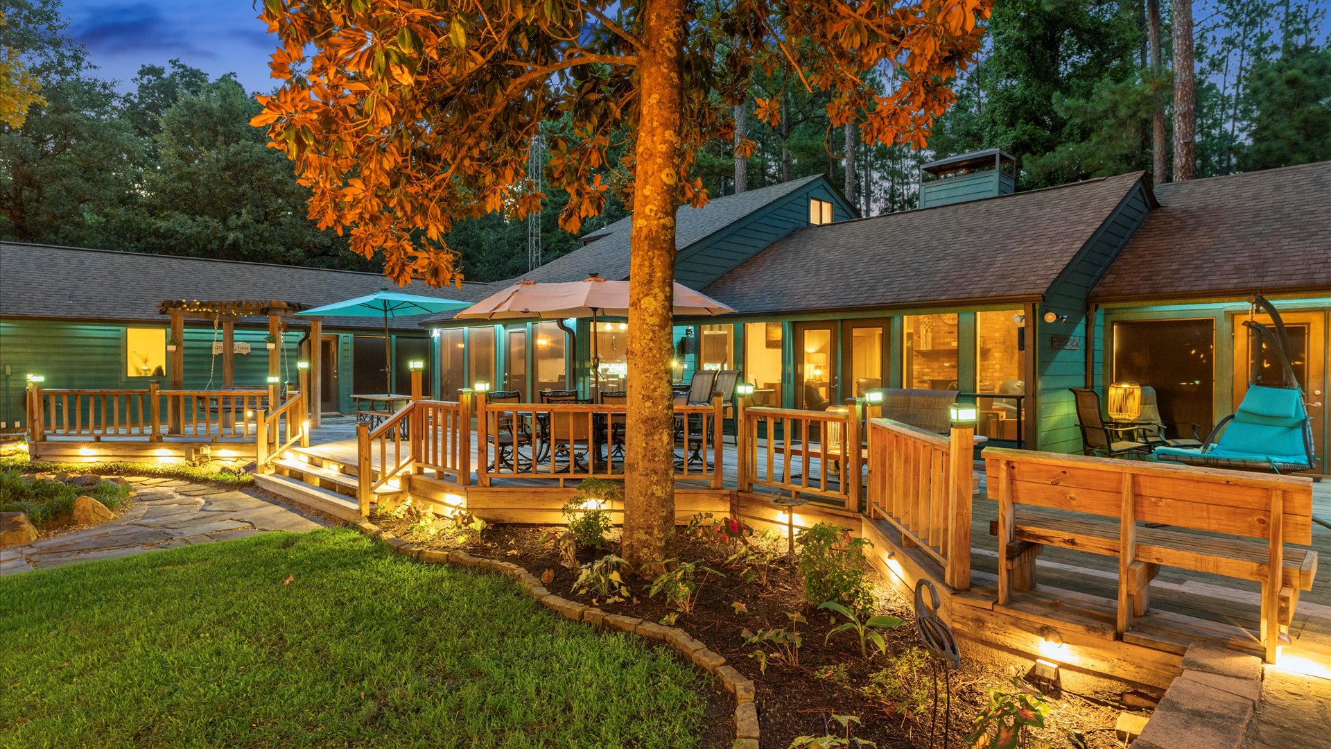 Back deck - connected to the house, offers large dining tables, bar seating, and swing seating for ultimate relaxation. Equipped with Bluetooth speakers, it’s the perfect spot for dining and hanging out.