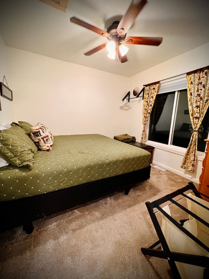 Home in the Woods, located upstairs, has a view of the lake and a king bed for 2.