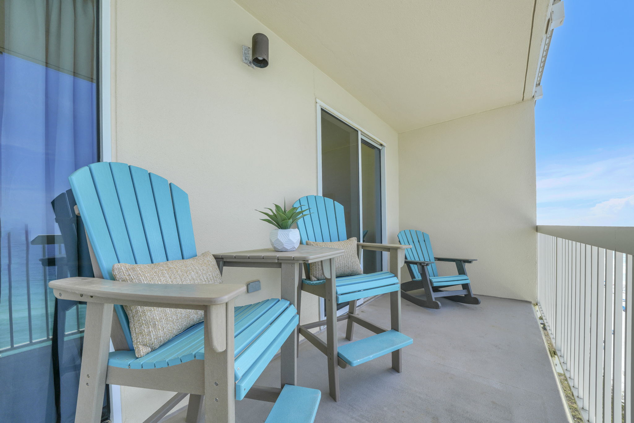 Relax on the balcony with seating designed for the view—two elevated Polywood chairs with a connecting table let you see right over the railing, while two Polywood rockers offer the perfect spot to unwind to the sound of the waves.