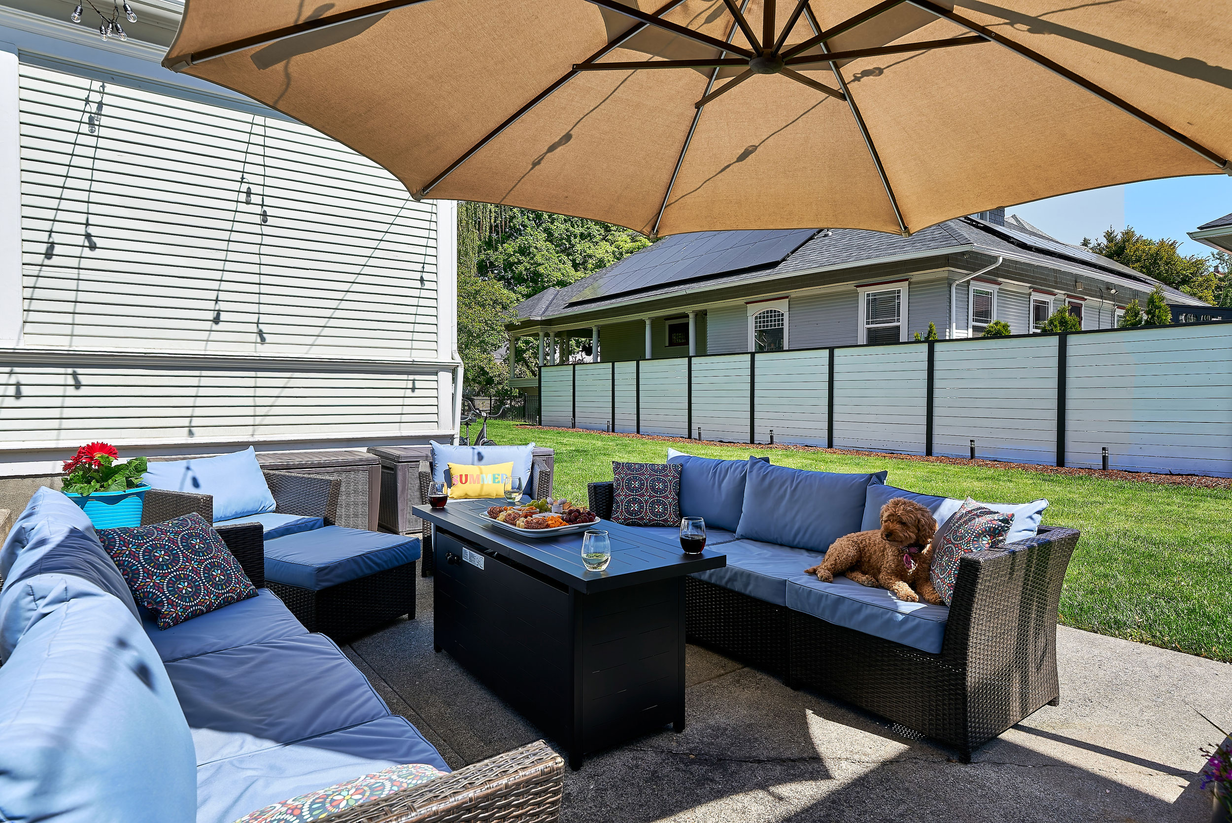 Back patio, surrounded by mature trees and historic charm and equipped with lounge seating and BBQ (propane provided)