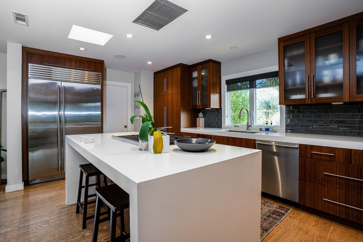 Fully stocked chef's kitchen with 8 person dining table and two person island seating.