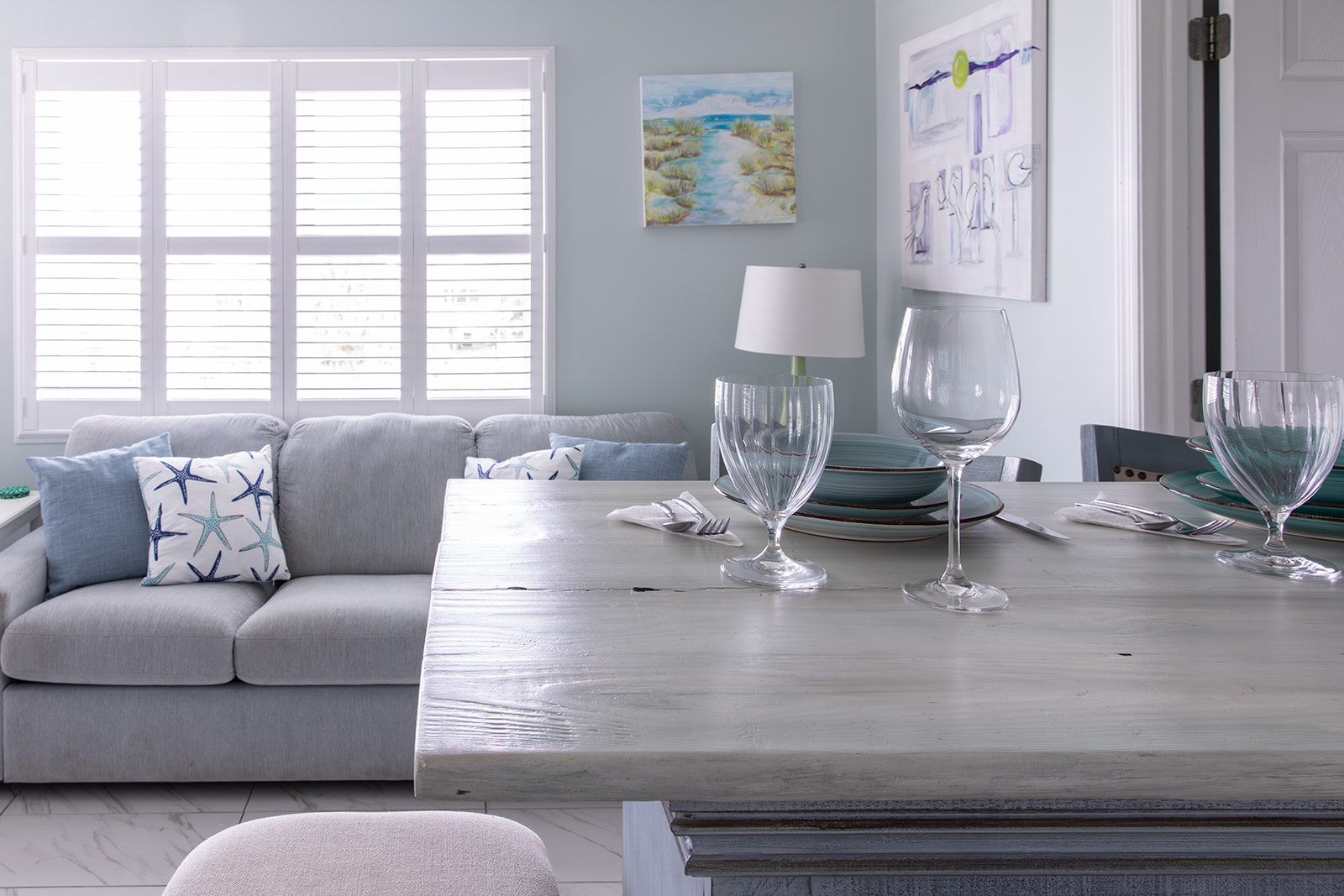 The kitchen island is set for two, with water glasses, wine glasses, plates, bowls, and silverware ready to go. A comfortable spot for breakfast, takeout, or sharing a bottle of wine at the end of the day.