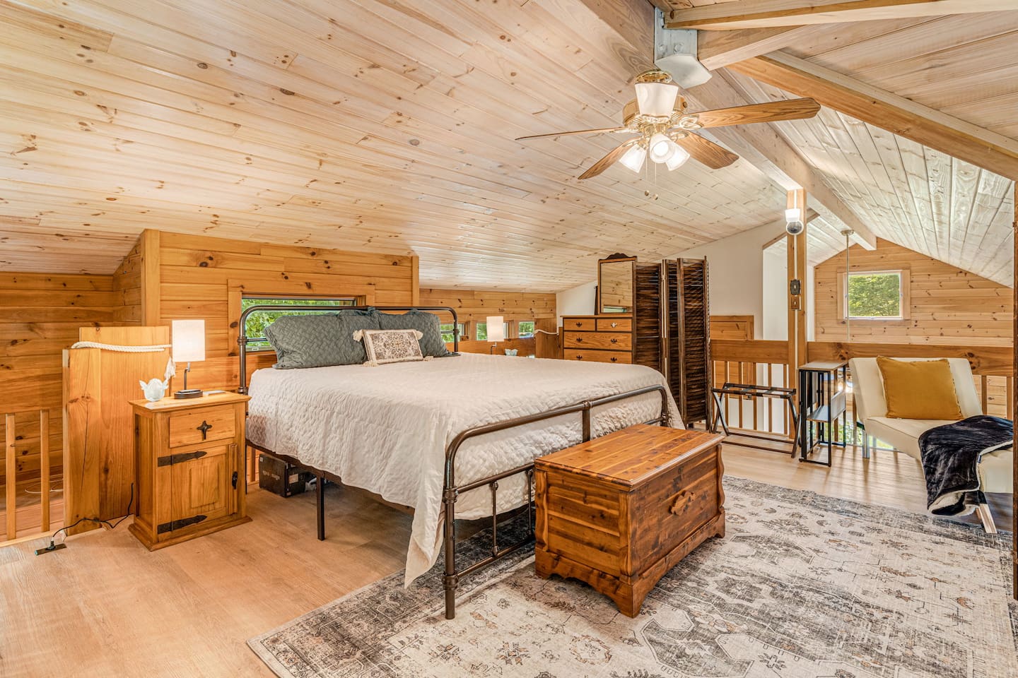 A warm and welcoming bedroom with a spacious and comfy king size bed perfect for a peaceful stay.