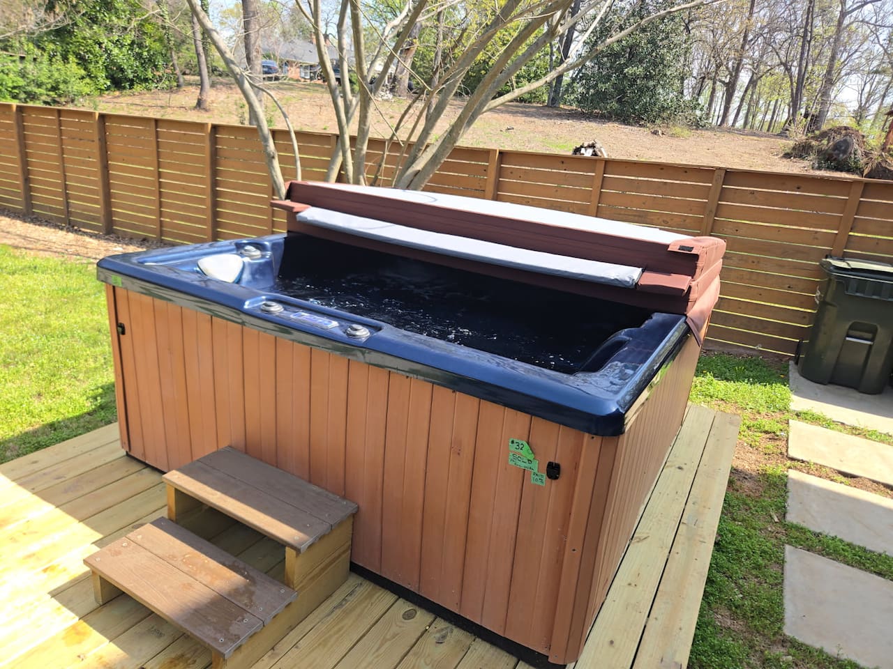 Unwind in your private outdoor hot tub, perfectly set on a spacious deck—ideal for relaxing evenings under the trees in this luxury Greenville stay.