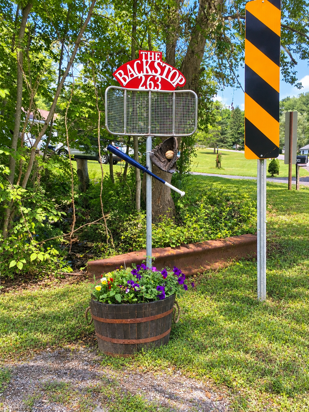 Backstop Apt, welcome sign at the driveway entrance.