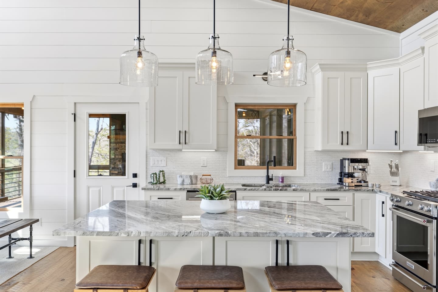 Bright, modern chef’s kitchen with a large natural stone island. Fully equipped with stainless cookware, sharp knives, Dutch oven, crockpot, rice maker, food processor, blender, teapot, and all essential utensils and gadgets.