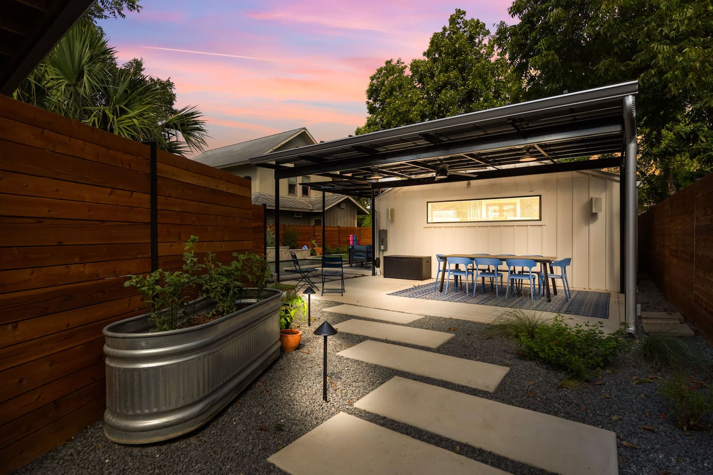 Dine al fresco under lights and enjoy dinner poolside or cocktails beneath the pergola.