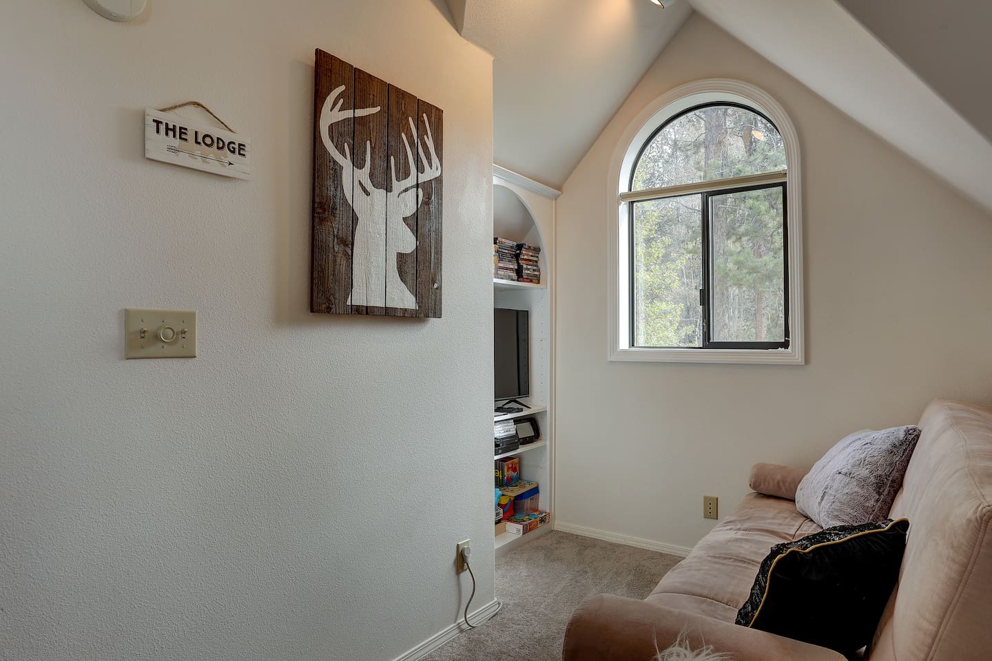 Upstairs, you'll immediately find a cozy loft with a futon for extra sleeping. Lots to do up here with a tv with blu-ray, plenty of DVDs, a Wii-U with lots of games, plus toys for the kids. 