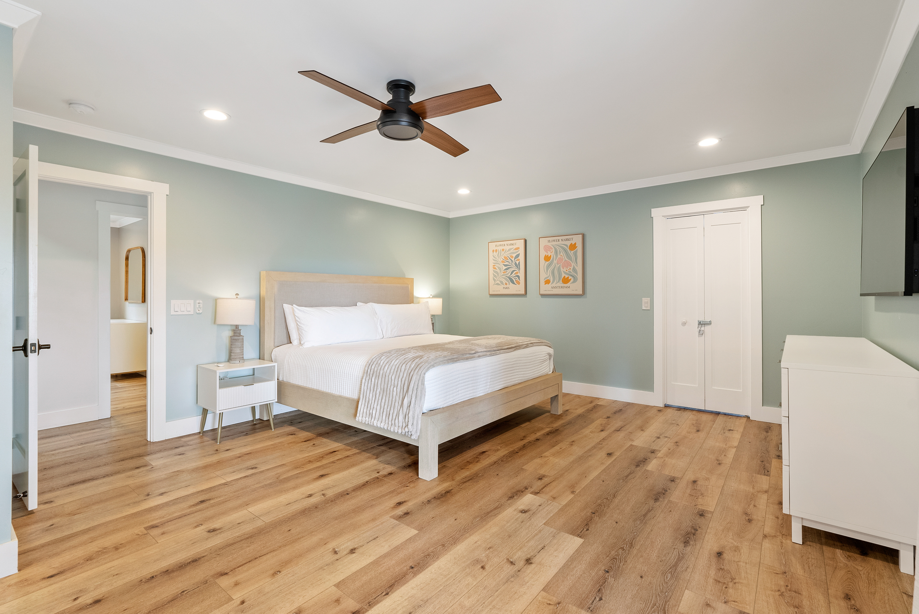 A calm, airy bedroom featuring soft colors and plenty of space to decompress.
