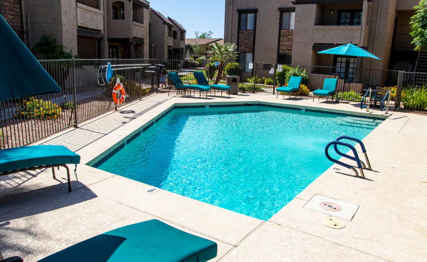 Shared community pool and spa area with lounge seating, sunny patio space, and room to unwind outdoors.