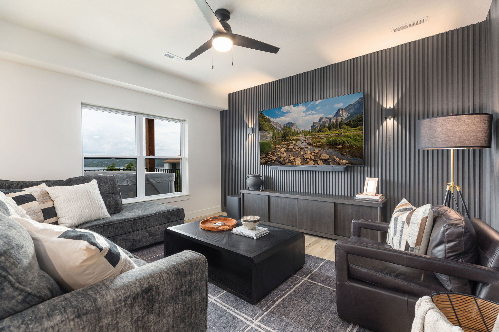Lower level living space with large TV and cozy sectional