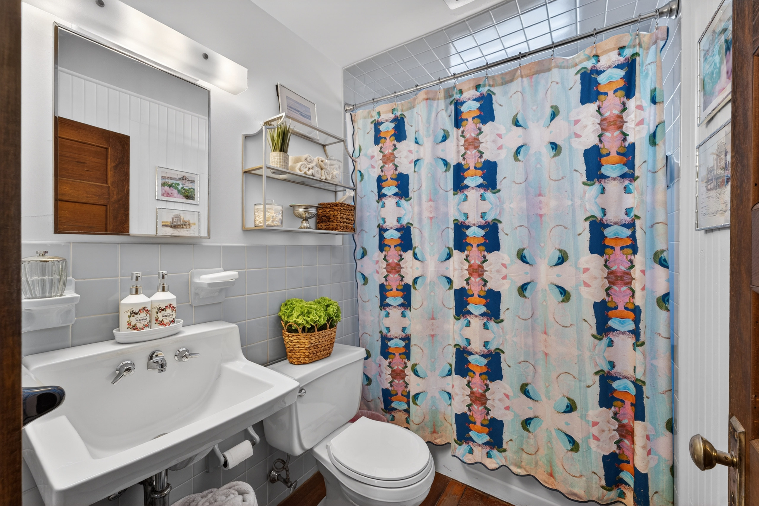 A bright and welcoming full hallway bathroom on the second floor, complete with a relaxing tub/shower combo!