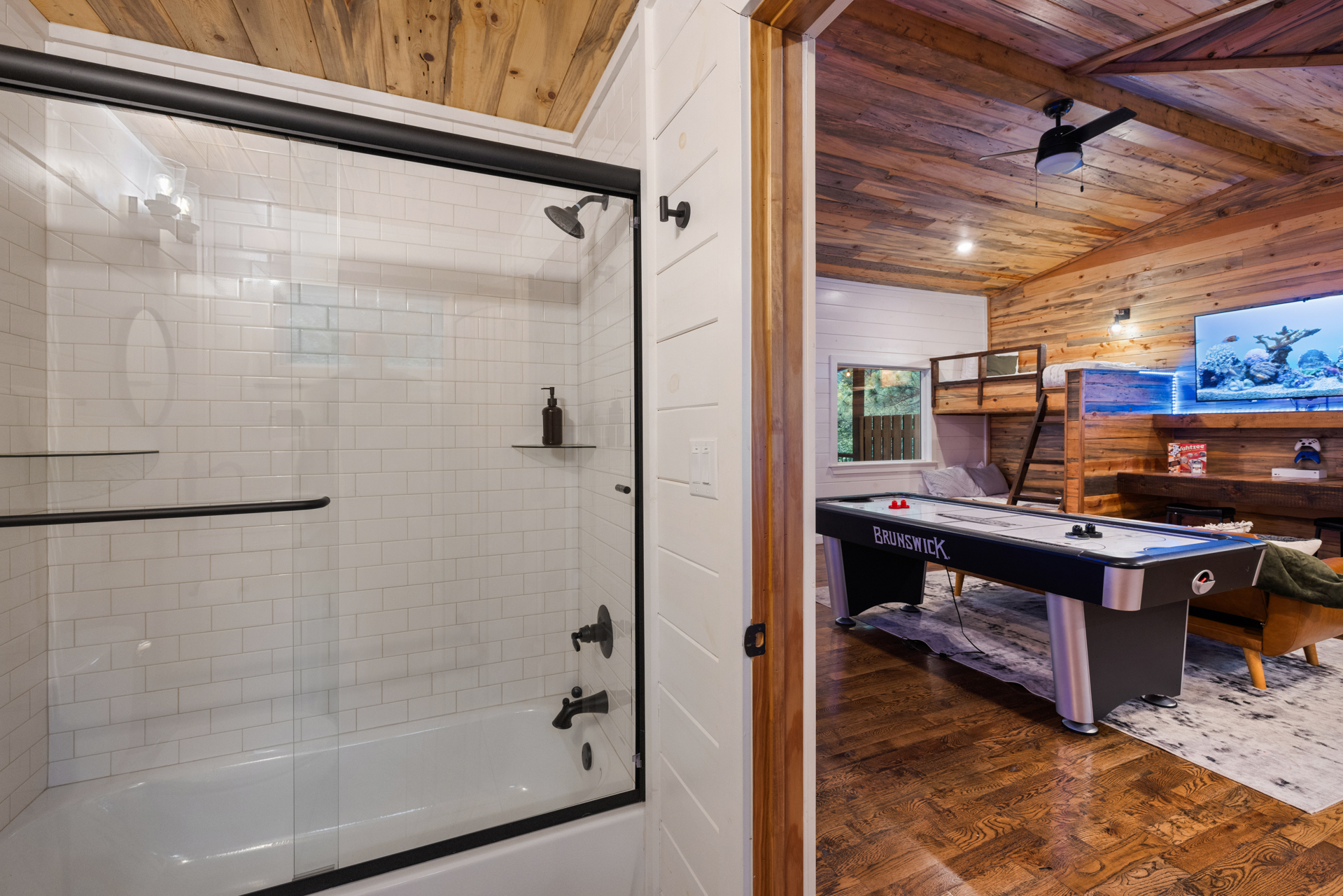 Featuring a full shower and tub combo, modern cabin finishes, and everything needed for relaxing resets after game room nights and outdoor adventures.