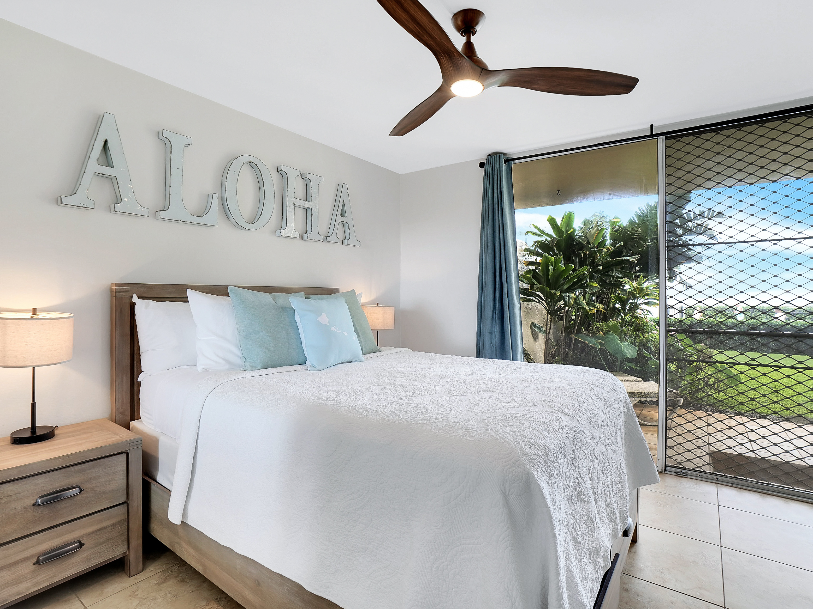 Second bedroom with plush queen bed and ocean view