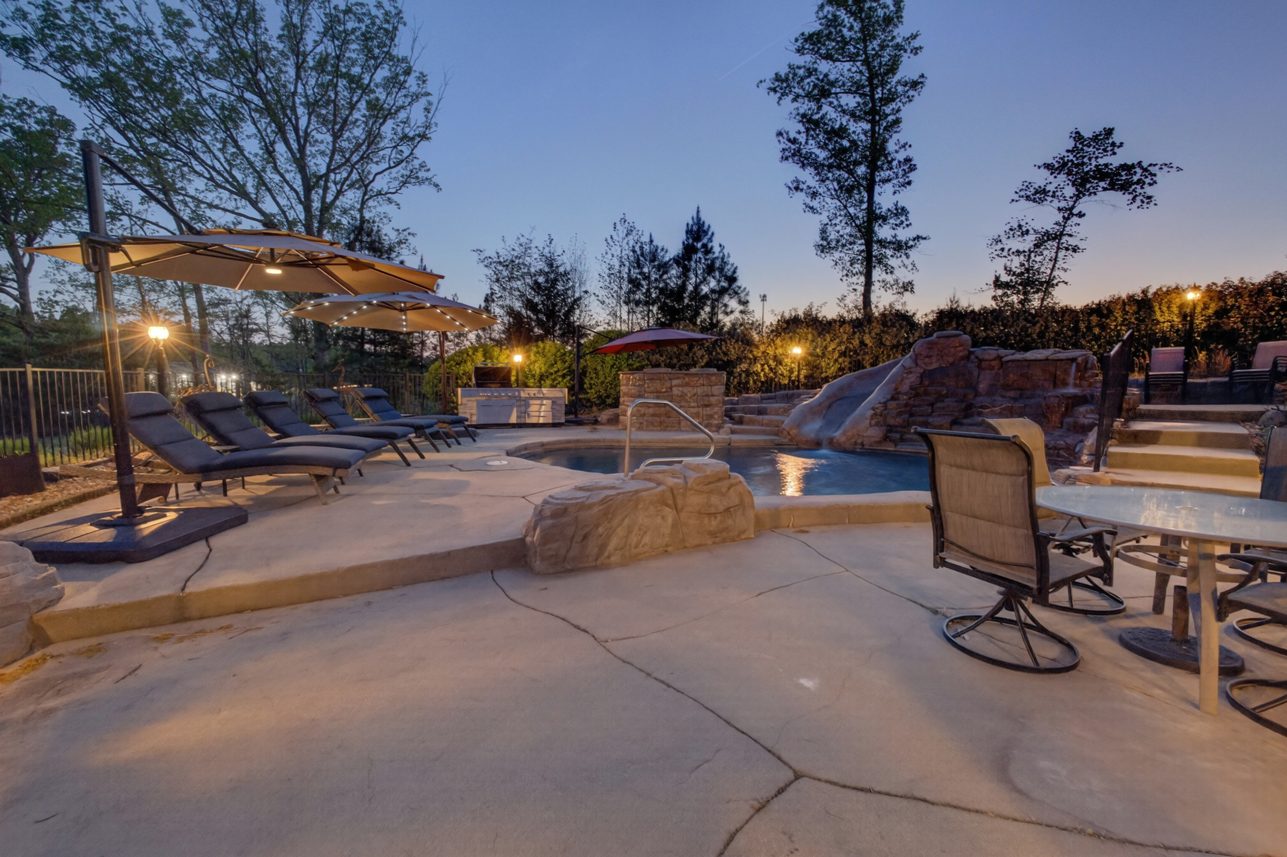 Private pool with waterslide and lounge seating for all-day relaxation