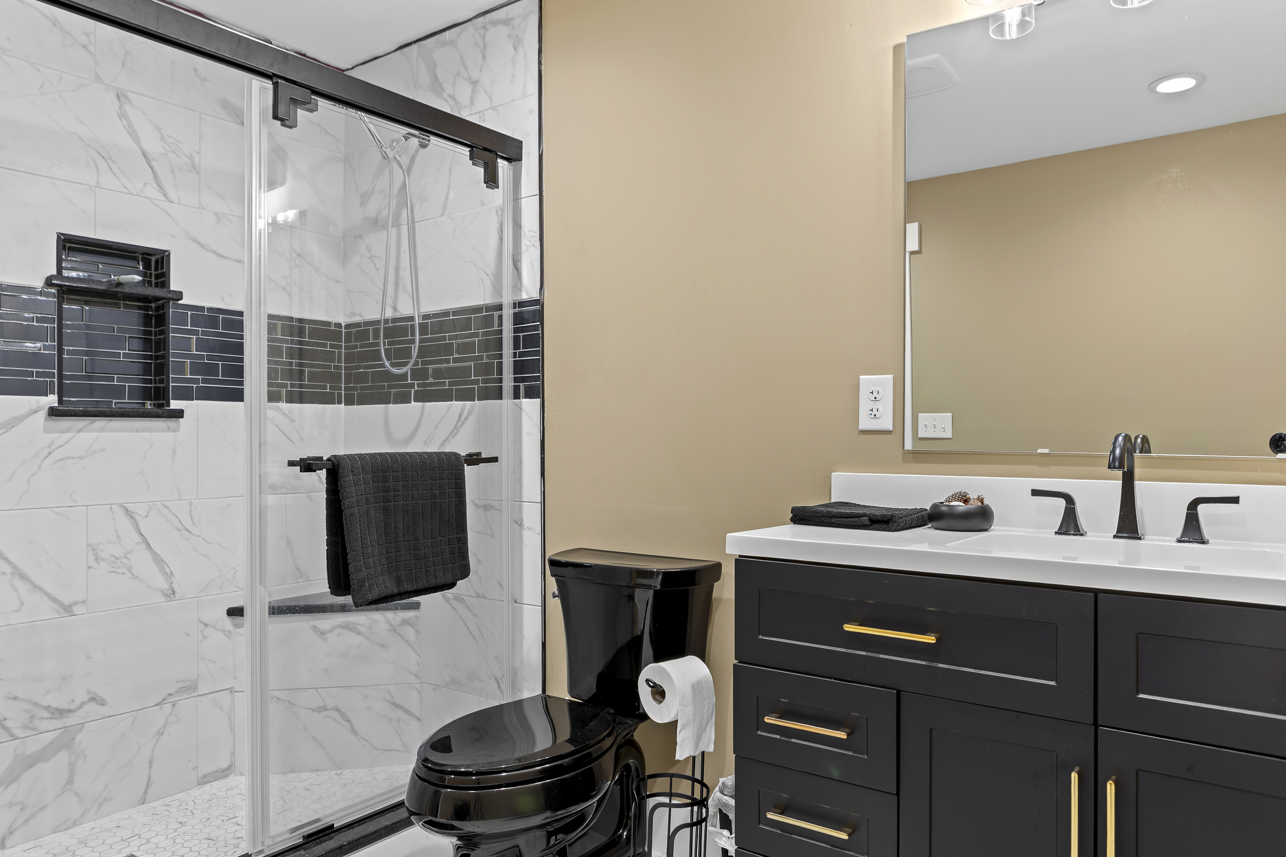 Bathroom Bliss: Stylish glass shower, modern fixtures, and elegant decor await your refresh!
