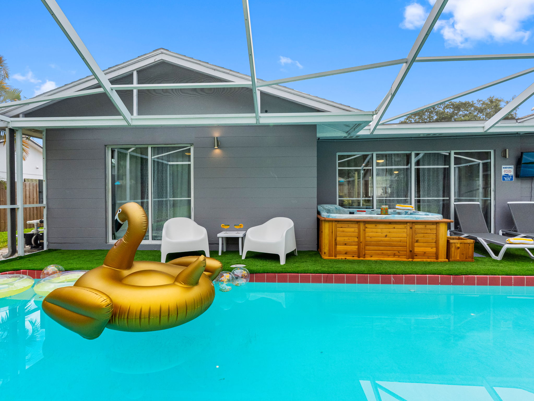 With its golden swan float, lush backdrop, and stylish layout, this pool deck is perfect for your next social-worthy moment.