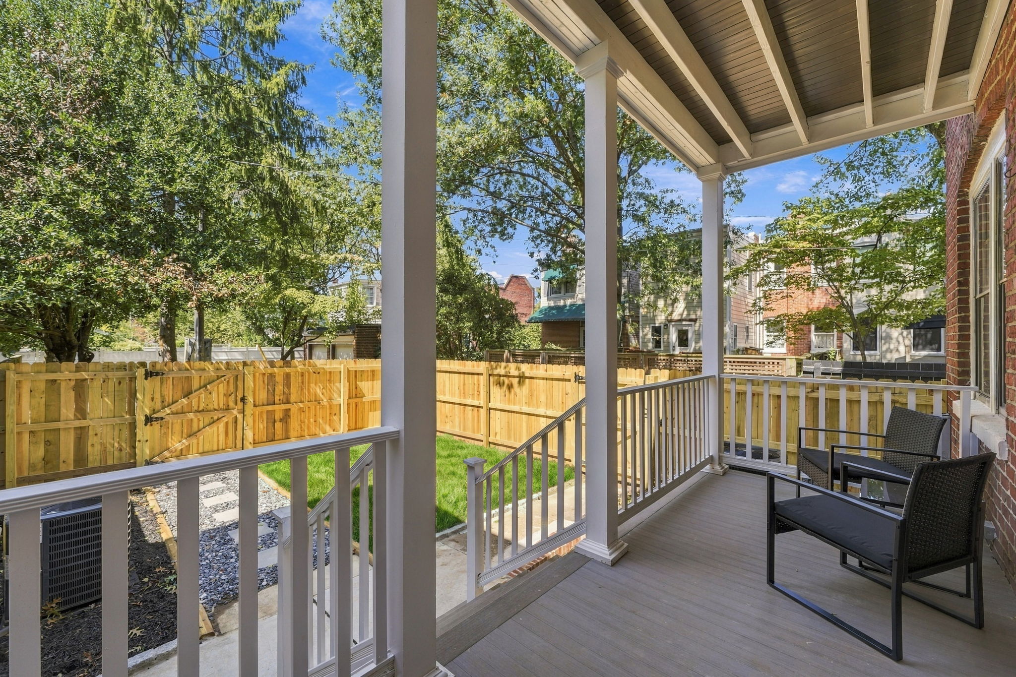 Porch Paradise: Relax on the sunny porch with views of the charming backyard oasis!