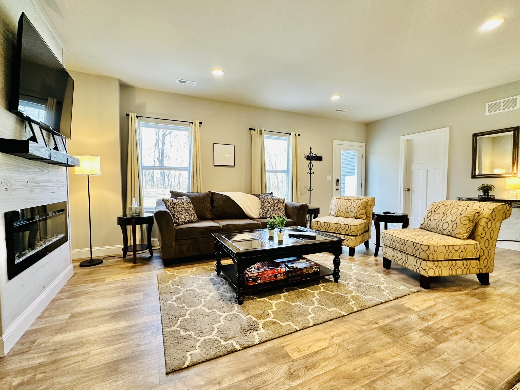 Living Room with built in electric fireplace, plenty of board games, and lots of natural light.