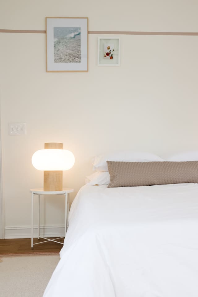 The "rose room" features a queen bed, accents from CB2, a desk for work-from-home, smart TV, a spacious double-door closet and a full bath with a shower tub. 