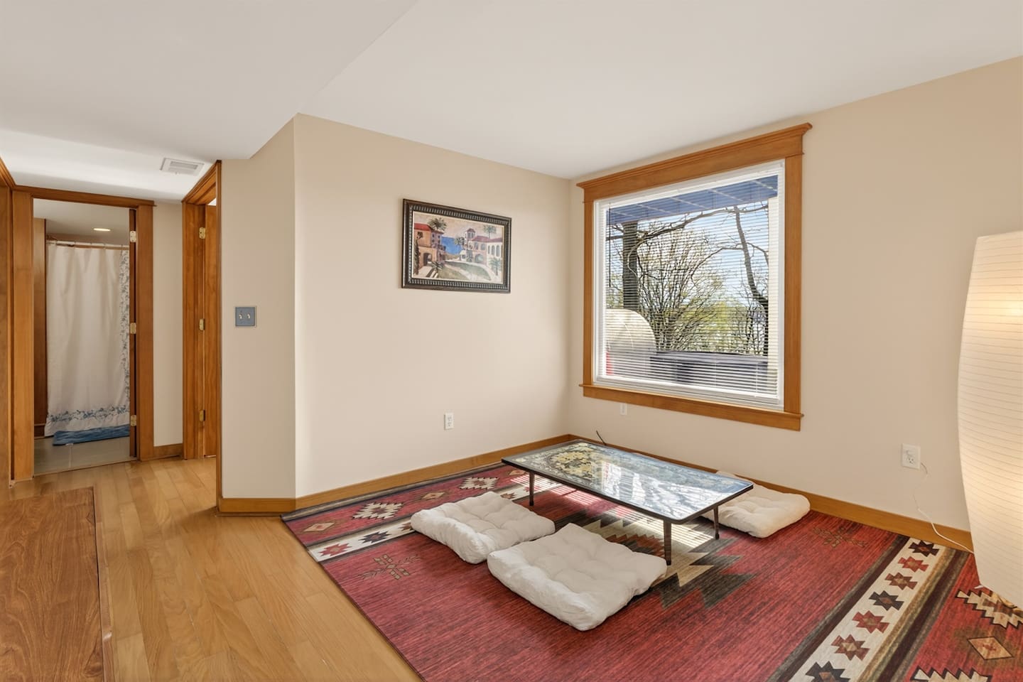 Relax in a Japanese-style living room with a low table, floor seating cushions, and warm, calming design—perfect for tea, conversation, or quiet moments, blending comfort and culture into a unique, peaceful retreat experience