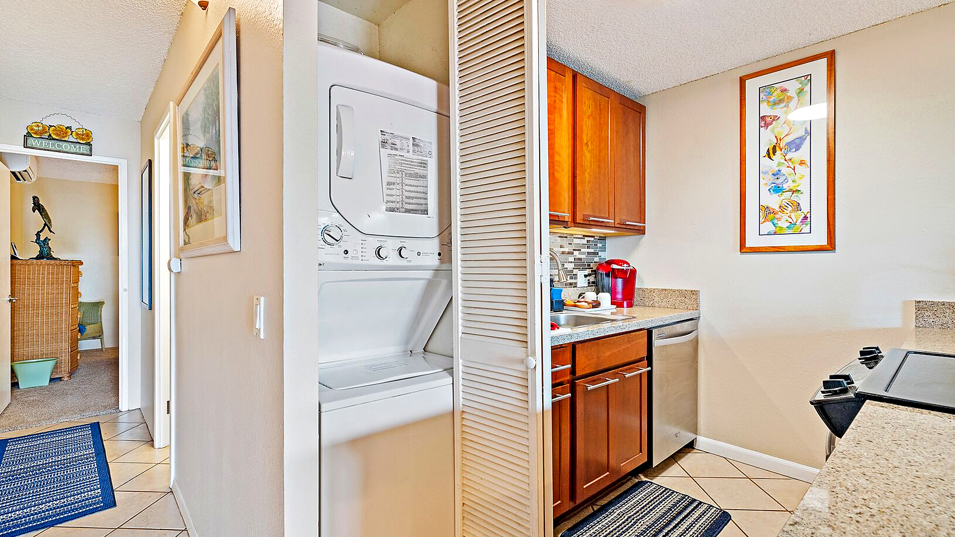 Stacked washer/dryer in unit.