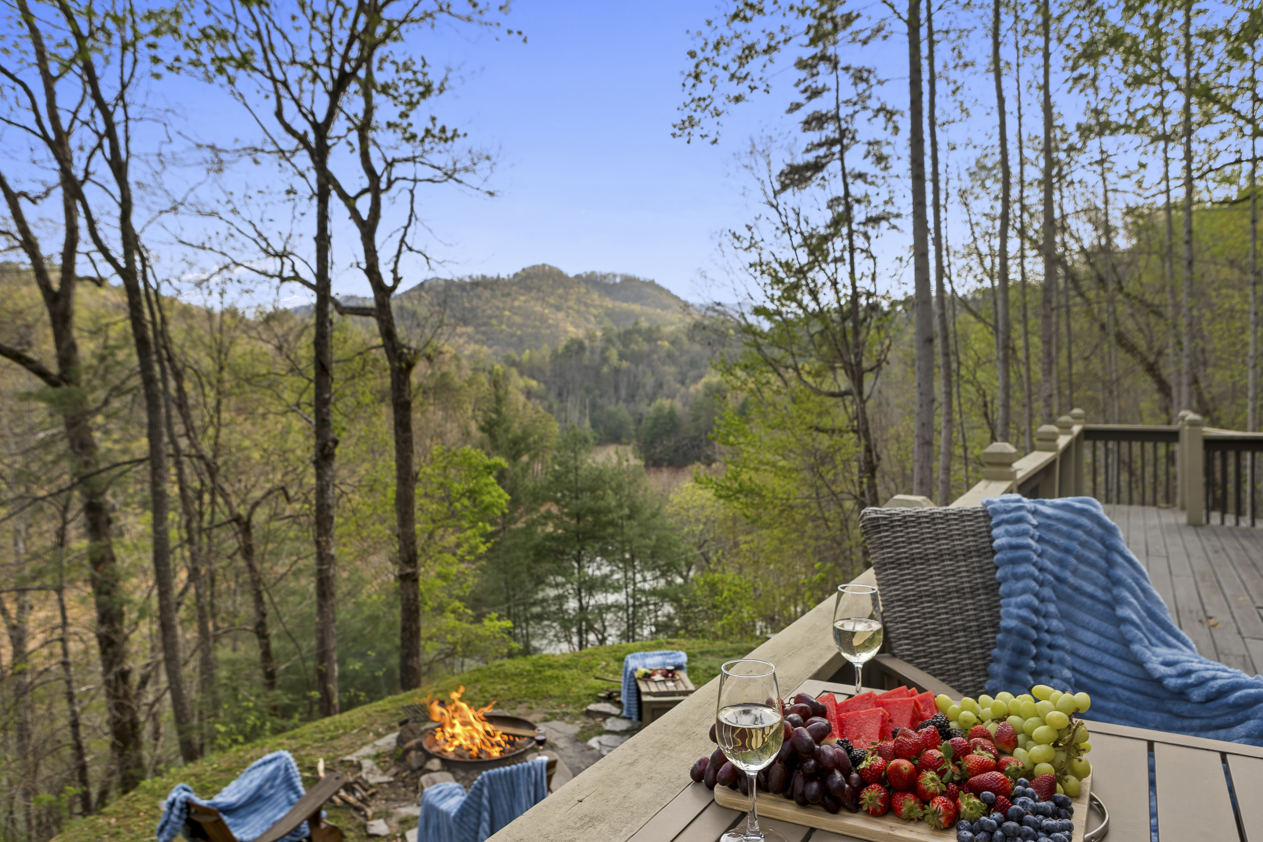 Deck Retreat: Savor gourmet bites and mountain views by the fire under endless blue skies!