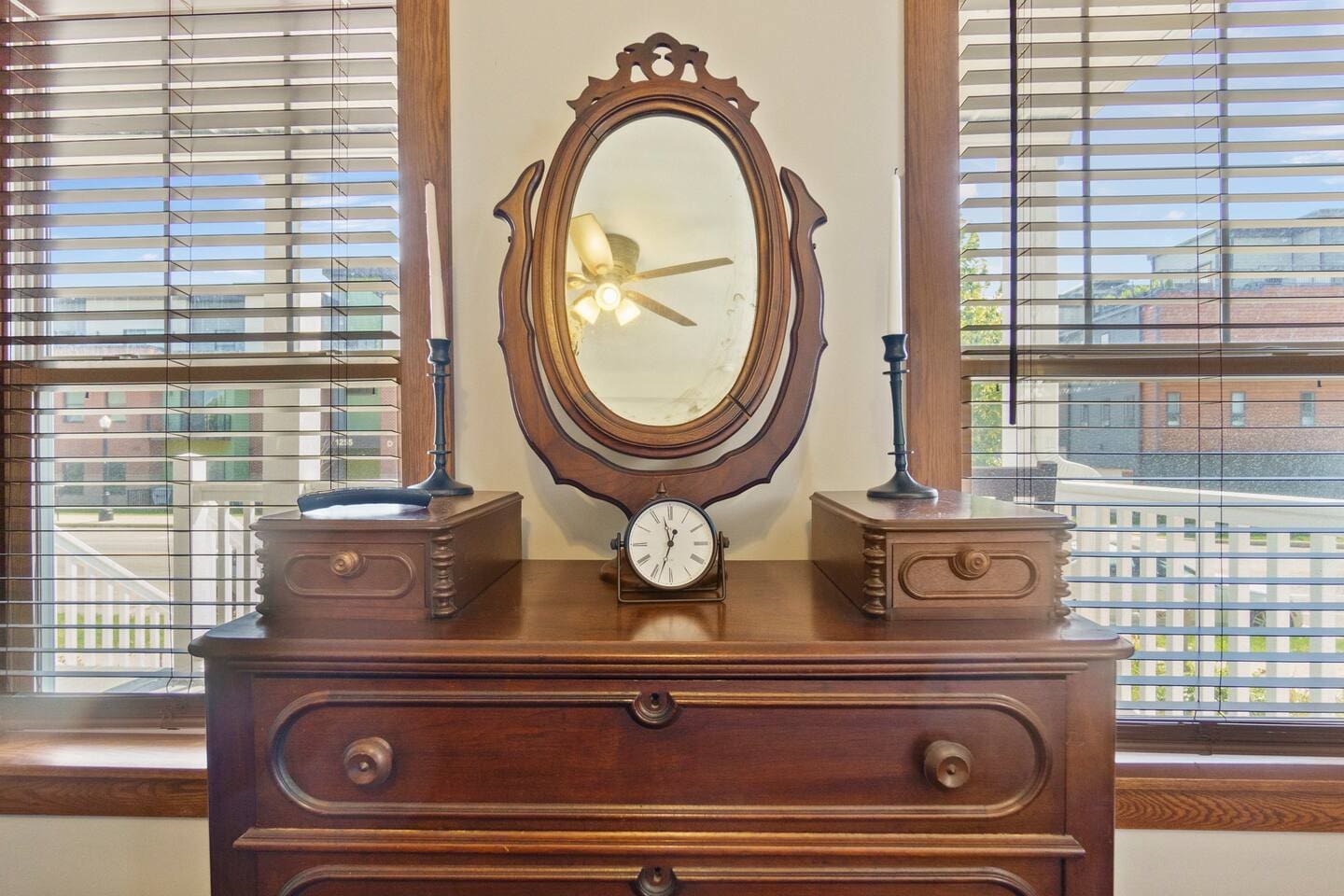 Elegant furniture setup featuring a table and mirror by the window, adding both style and functionality to the space.