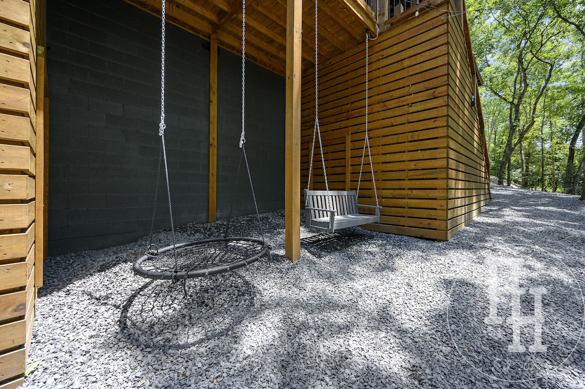 Porch swing and spider web swing facing the creek