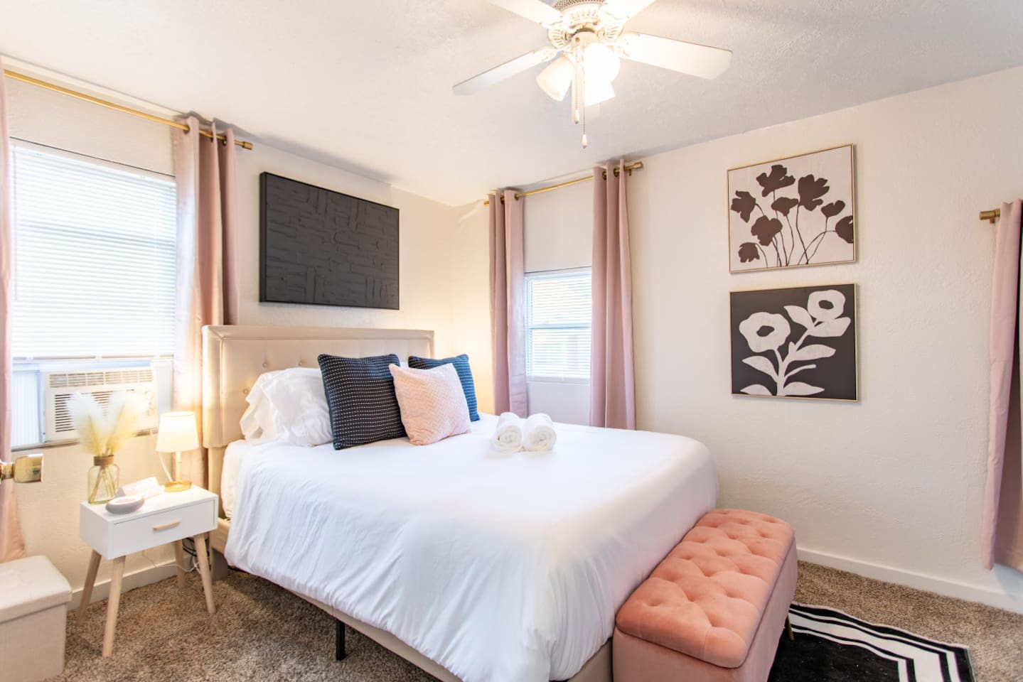 A cozy bedroom with windows on each side, allowing natural light to flood the room and create a bright, airy atmosphere for a peaceful retreat.