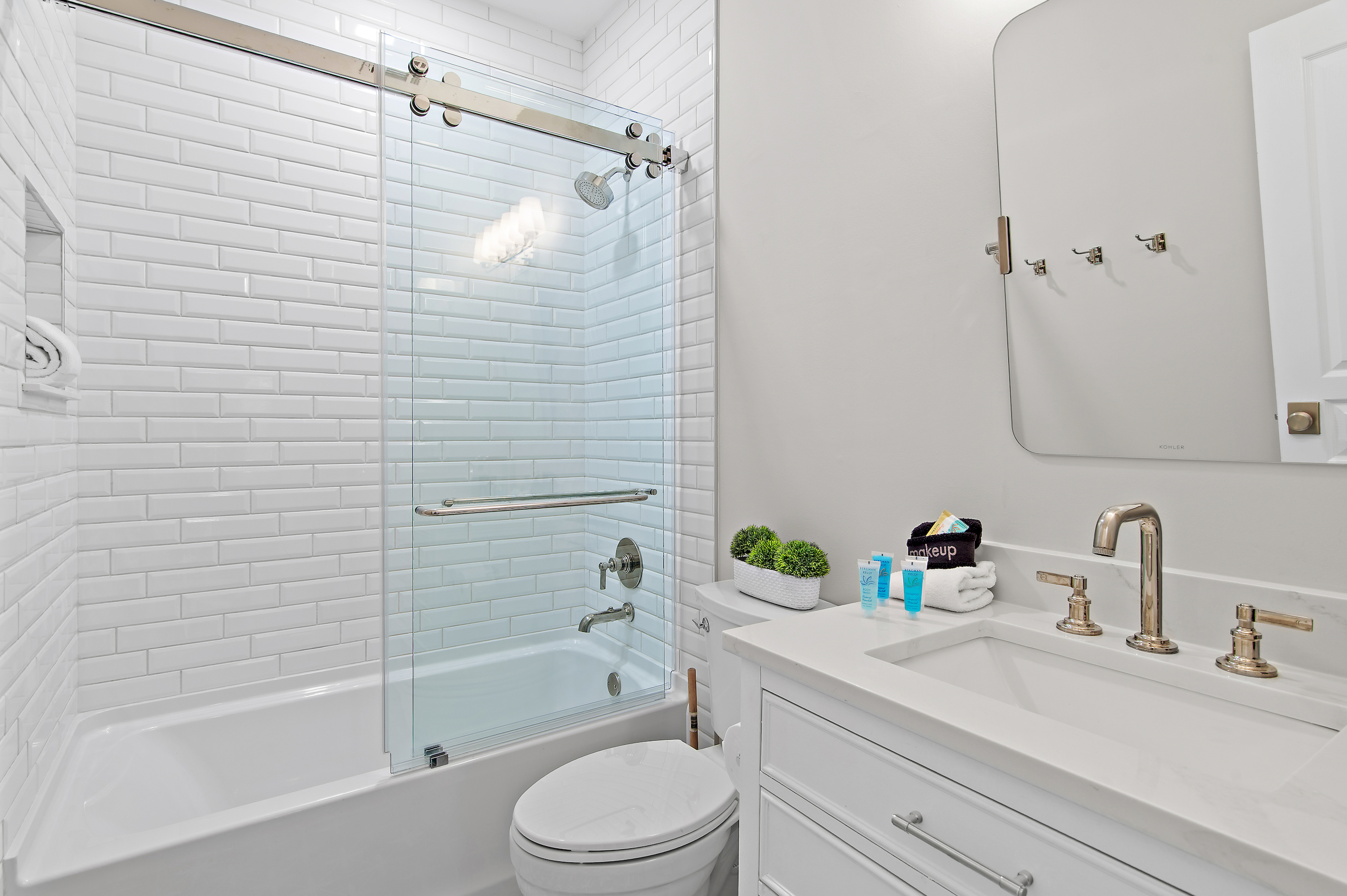 Clean, modern bathroom with tub and shower combo