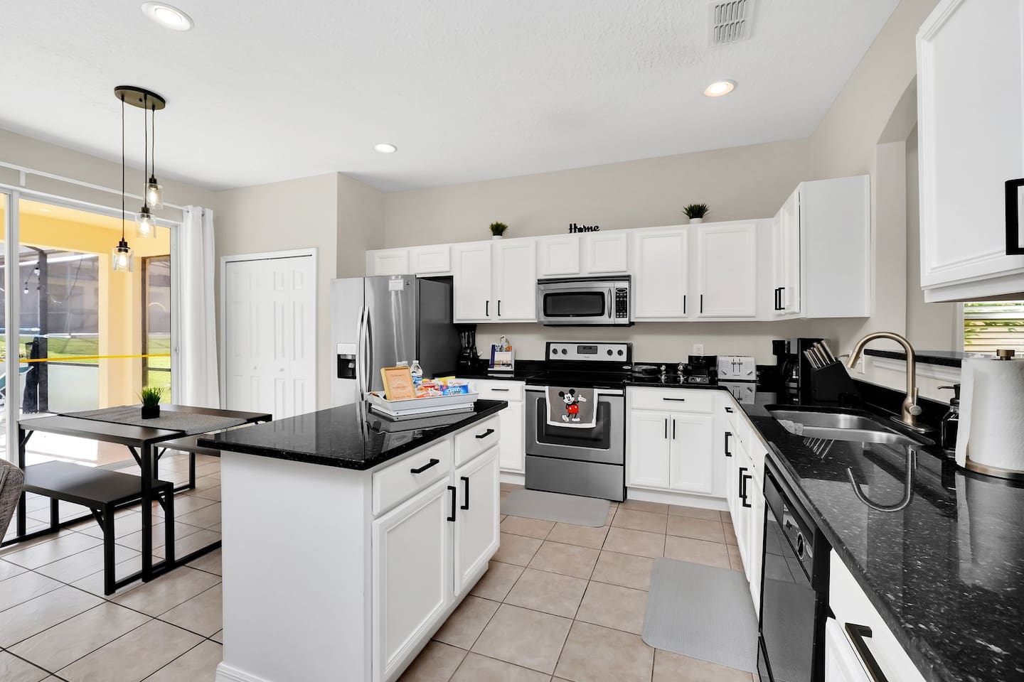 Modern Kitchen, fully stocked with cooking utensils, pots, pans, dinnerware, cups, wine glasses and more!