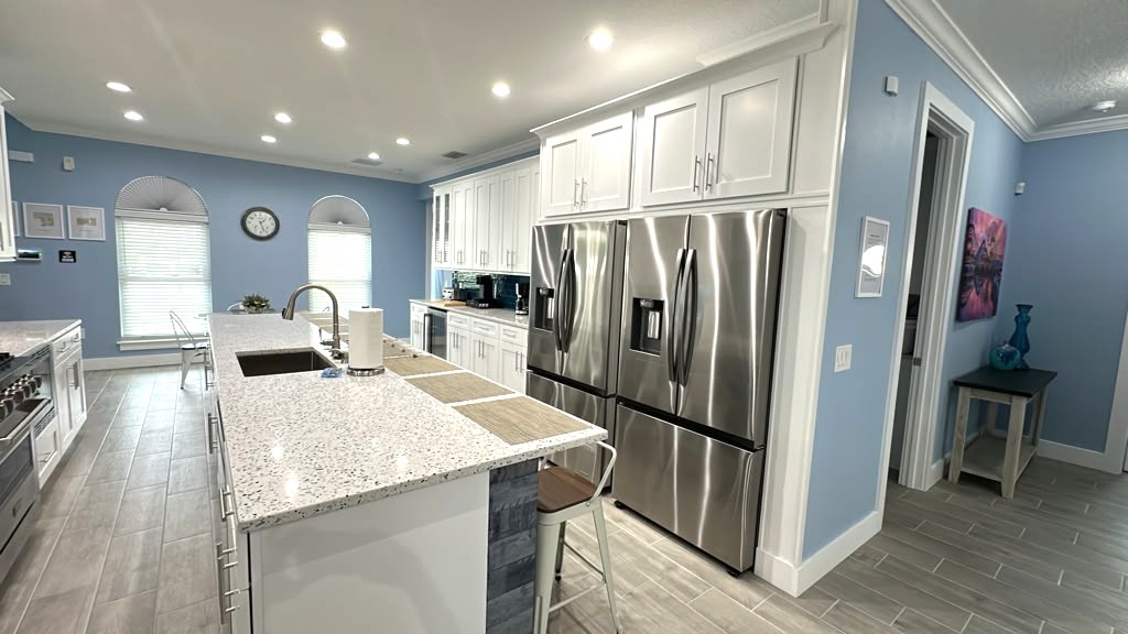 Chef Kitchen with huge island, range, two fridges, drinks fridge, and more. 