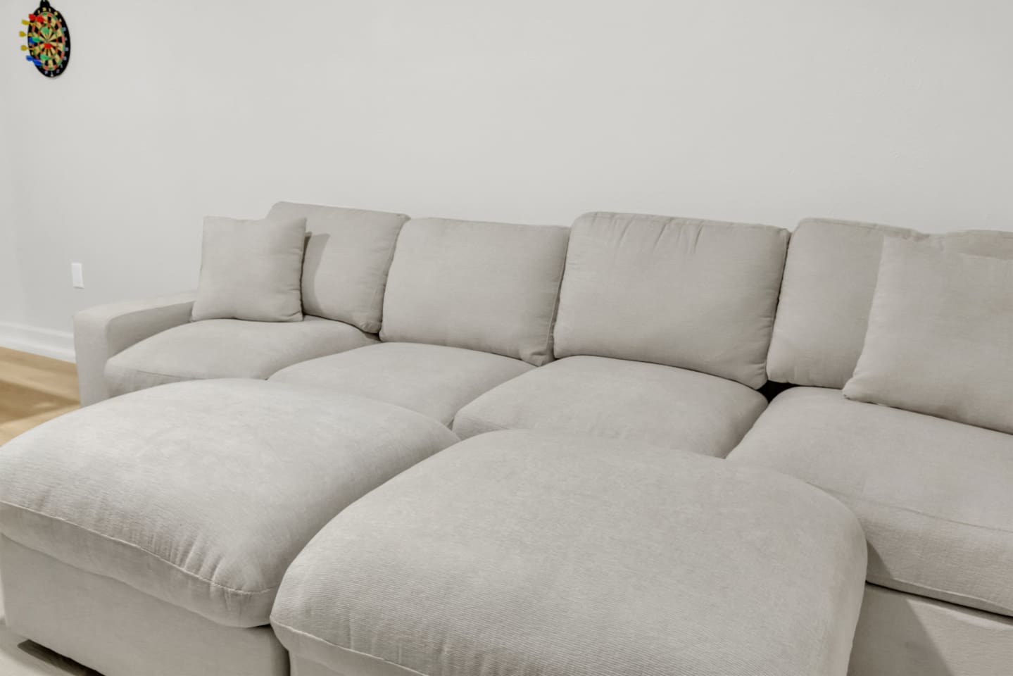 Oversized sectional in the cinema/game room, offering plenty of room for the whole group to unwind after exploring Grandscape or Topgolf.