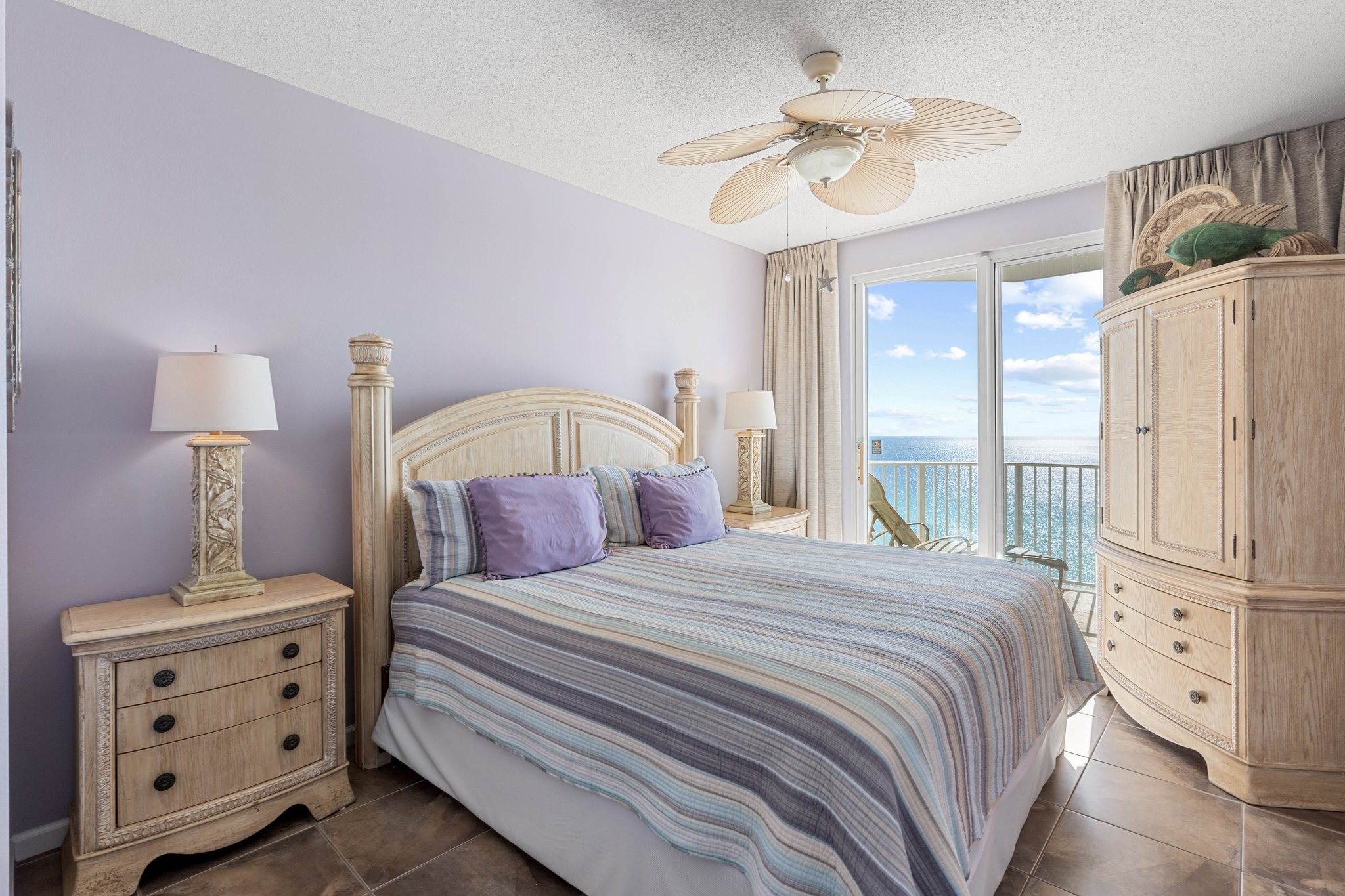 Primary bedroom w/ king bed, soft lighting & a calm coastal feel.