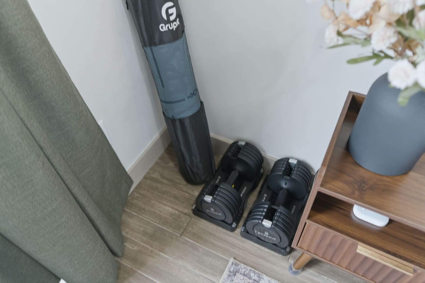 Fitness corner inside the bedroom with adjustable dumbbells—perfect for keeping up with your workouts while traveling.