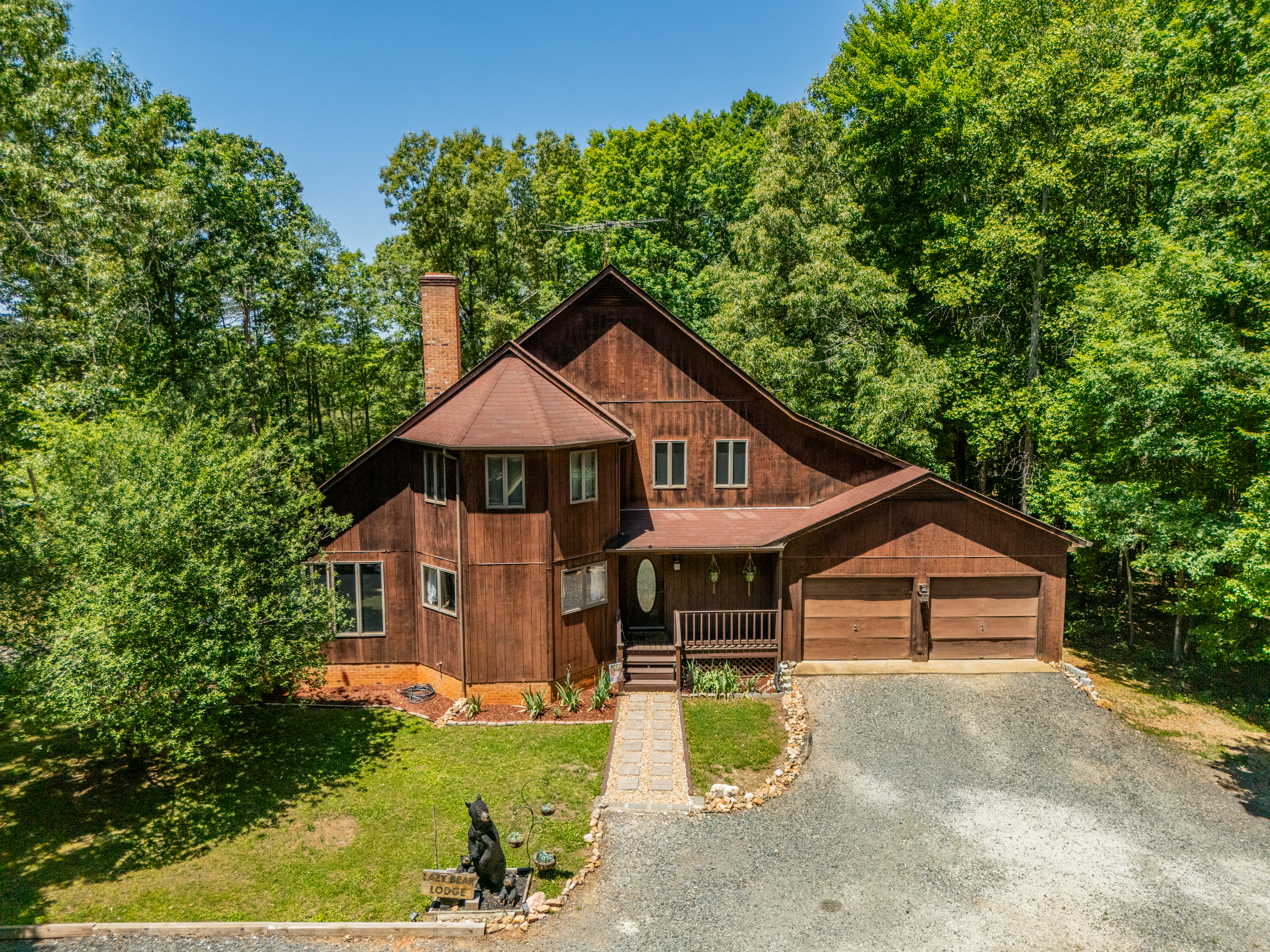 Exterior Retreat: Nestled among lush trees, this charming lodge invites adventure and relaxation!