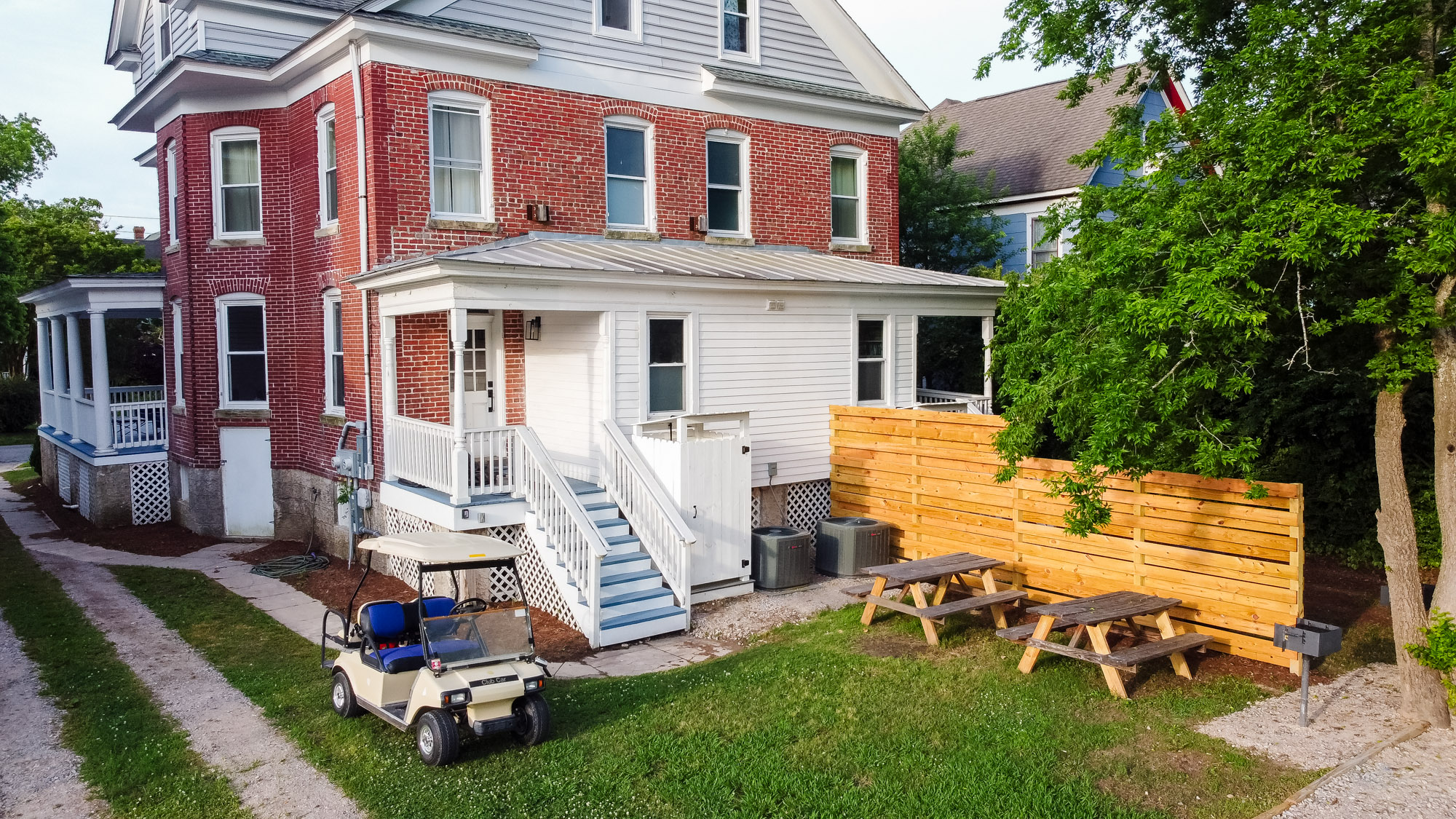 Shared backyard offers additional parking. A BBQ grill and outdoor seating have been recently installed behind the house on each side as well.