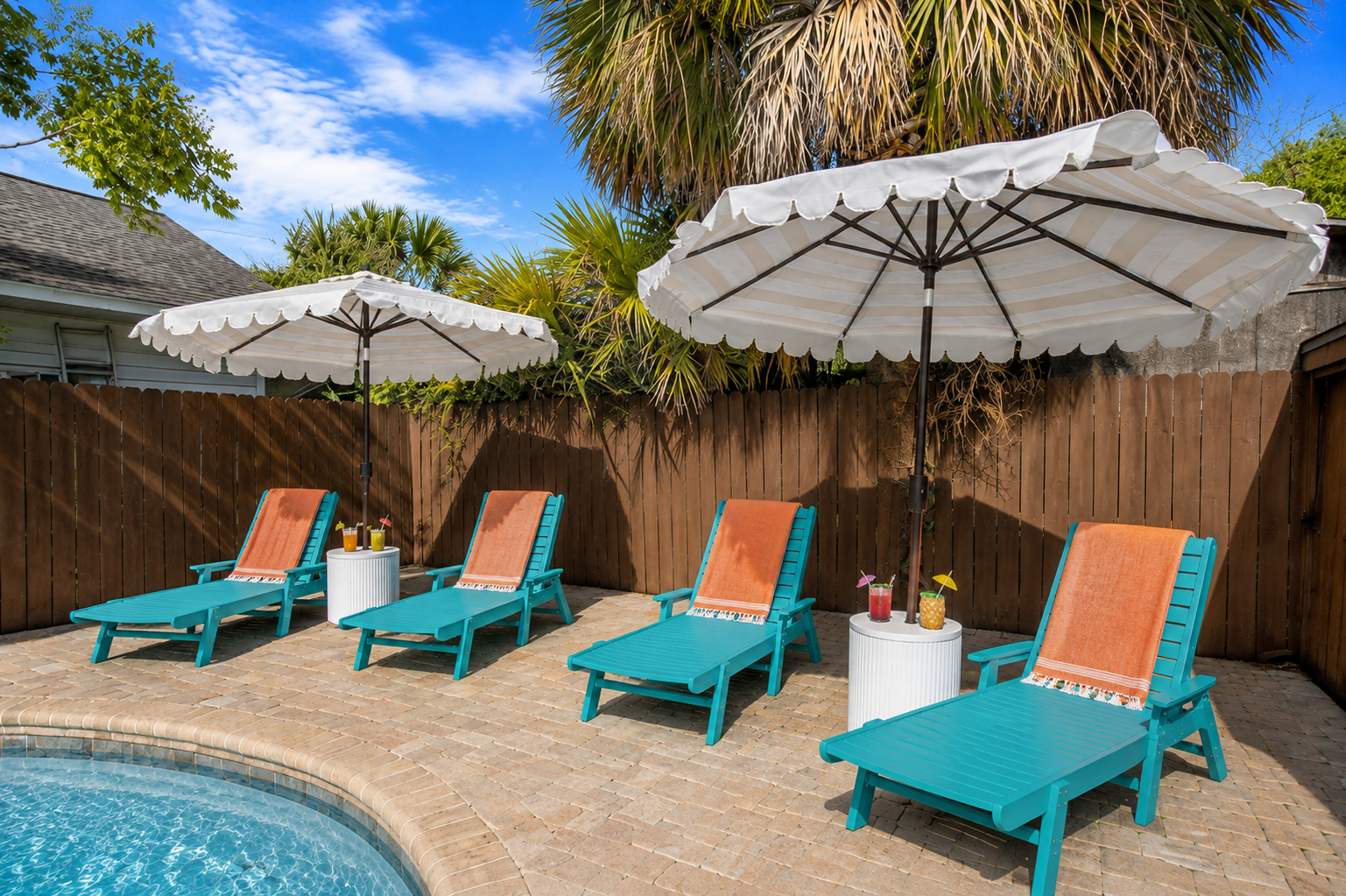 Line up all four turquoise chaise loungers for your crew and
claim your spot in the shade of a white market umbrella. Peak
relaxation mode unlocked. Don't forget your drink!