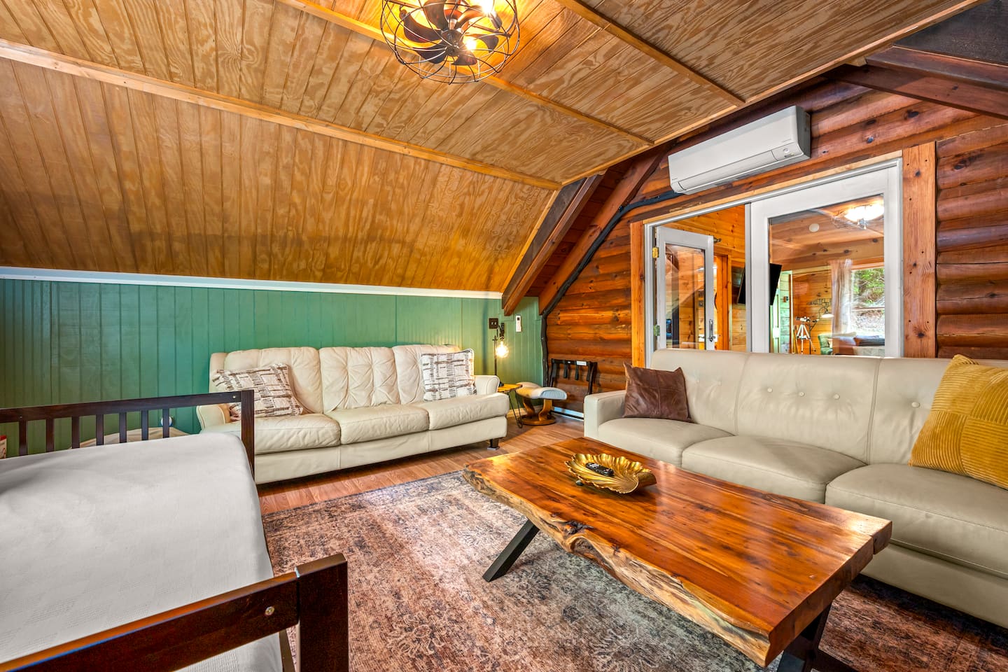 Additional cozy lounge space with comfortable seating, warm wood finishes, and a relaxed cabin atmosphere. 