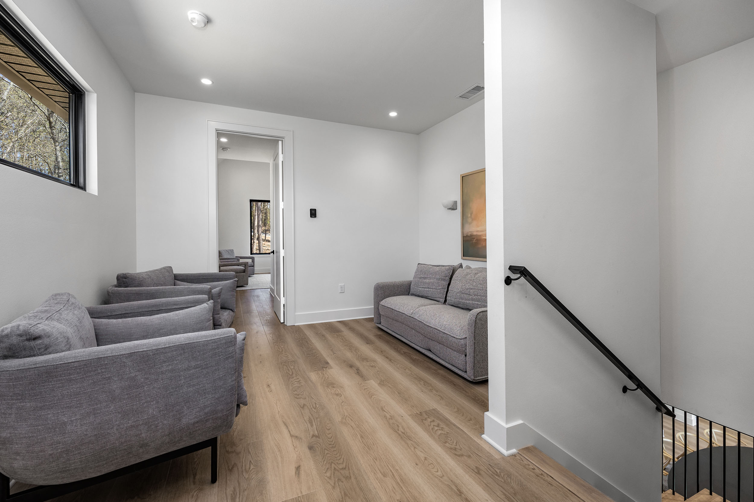  A cozy upstairs landing provides an extra sitting area and space to unwind, read, or work if needed.