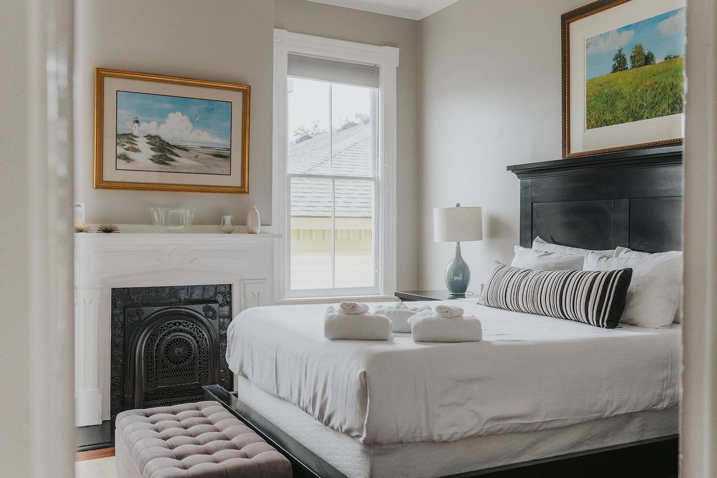 Well appointed bedroom with a queen mattress and high-end furnishings.  Two large windows between the ornate slate fireplace invite you in to kick your feet up and watch the game, read a book, or take a guilt-free nap.