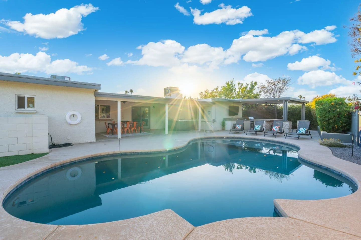 Sunrise over the pool, with the whole backyard stretched out behind it — this is where mornings start slow and afternoons never do.