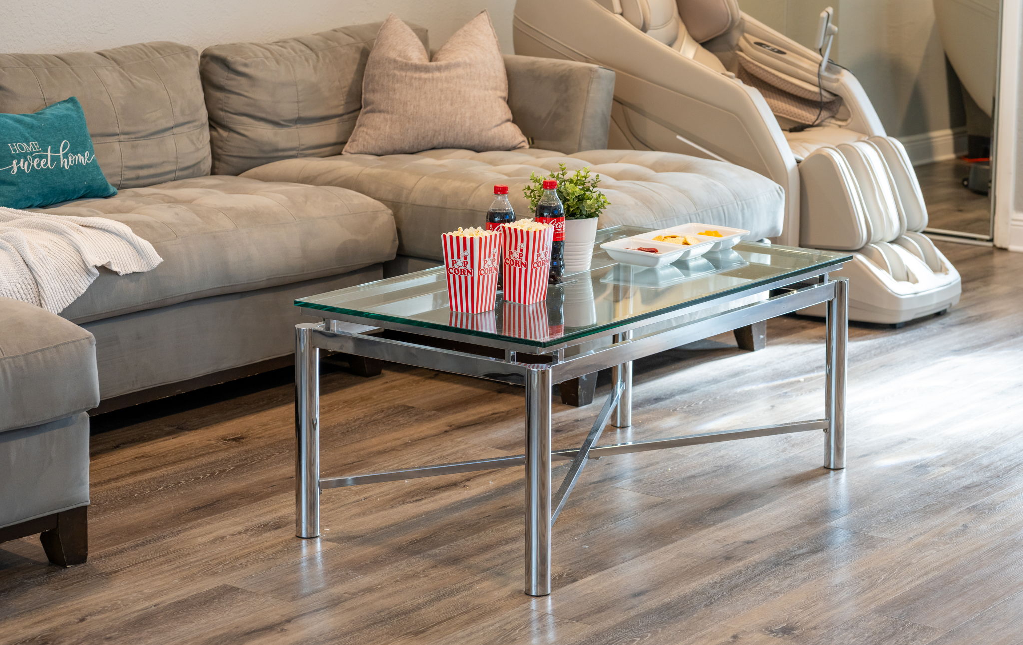 Ample seating, sleek surfaces, and open connectivity to the dining and kitchen areas make this living room perfect for hosting guests.